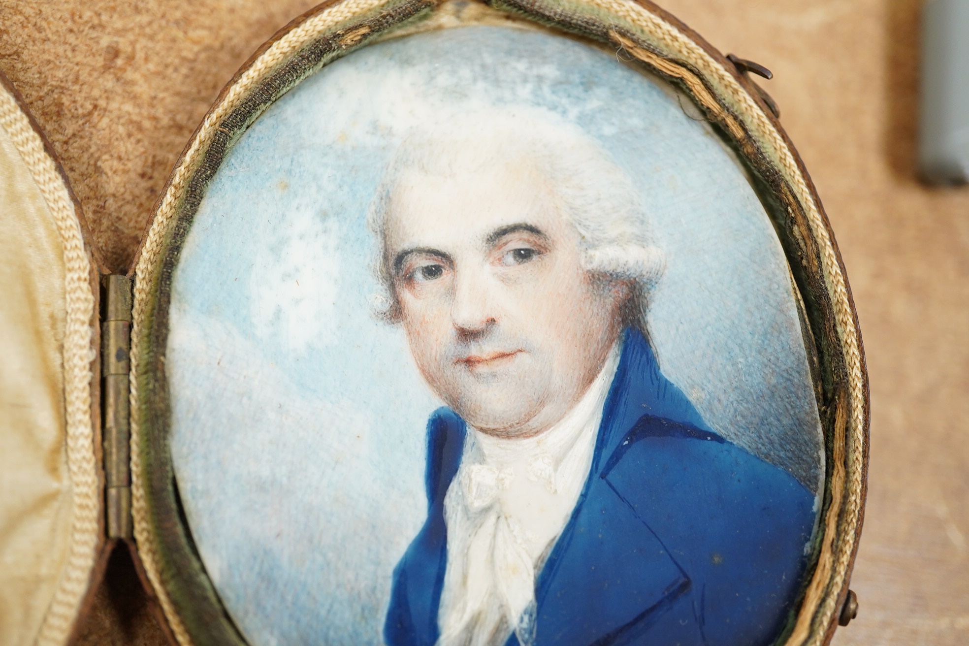 18th century, English School, oil on ivory, Portrait miniature of a gentleman wearing a blue frock coat, 7 x 6cm, housed in original Moroccan leather case. CITES Submission reference 3C2DKCRV. Condition - poor